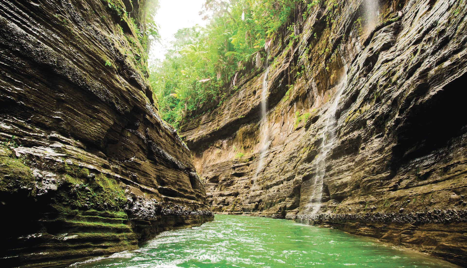 Narrow canyon walls with small waterfalls on the Navua River, Fiji