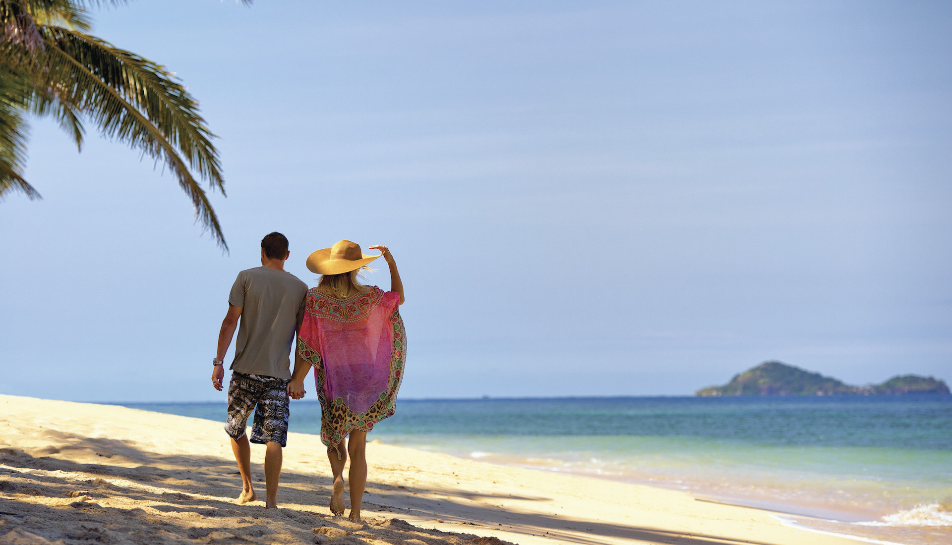 Couple walking on beach in Fiji